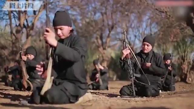 In the footage, the young Chinese ISIS fighters are shown how to use rifles