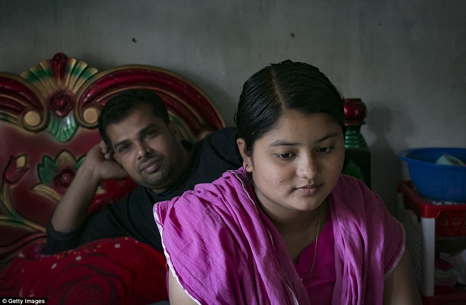 The teenager sits with her husband Liton. The girl's own mother had married when she was just 16 and her grandmother had been just 17