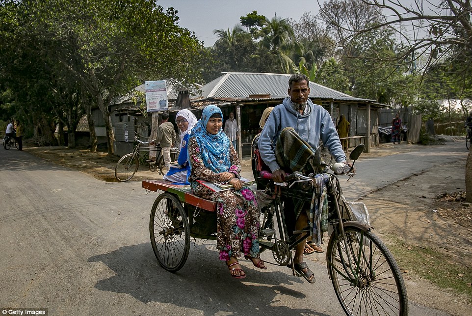 Rani  rides on a rickshaw. She said the harassment was so bad that she can't walk around her village without wearing a burka