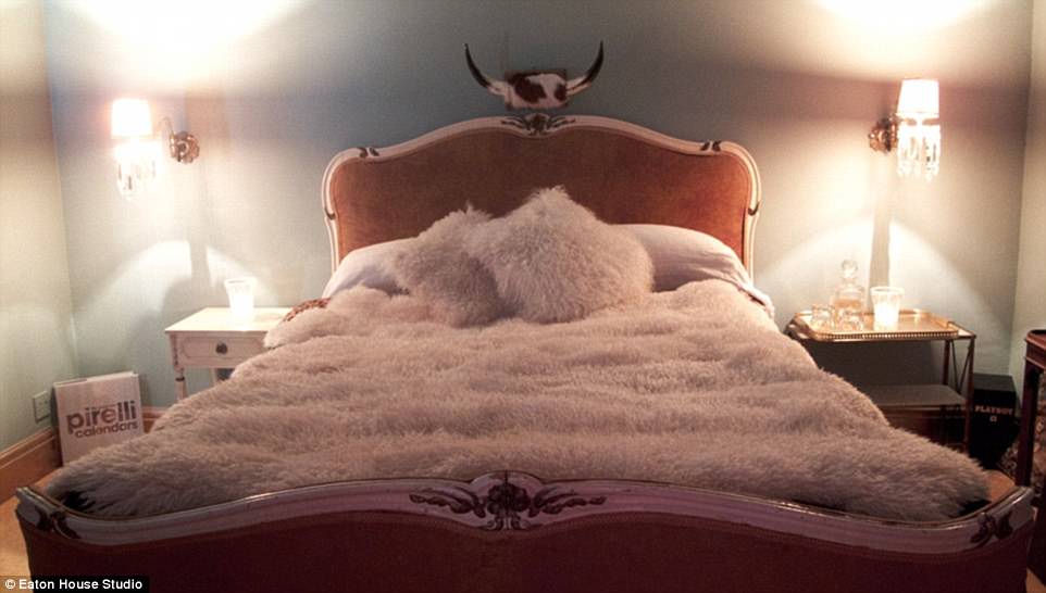 The Quintessential Cowboy room features a Western look: Horns over the bed, a fluffy throw and pillows