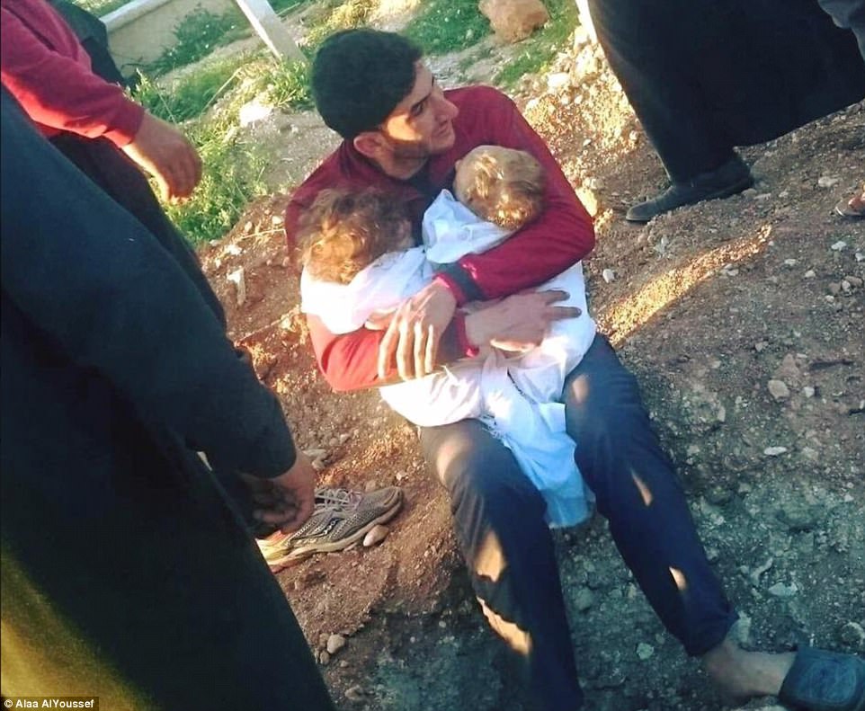 The man, who has not been named, was seen sitting on the ground as he hugged his young children following Tuesday's attack. Renewed air strikes hit Khan Sheikhoun on Wednesday. No casualties were reported because the area had been evacuated following Tuesday's attack