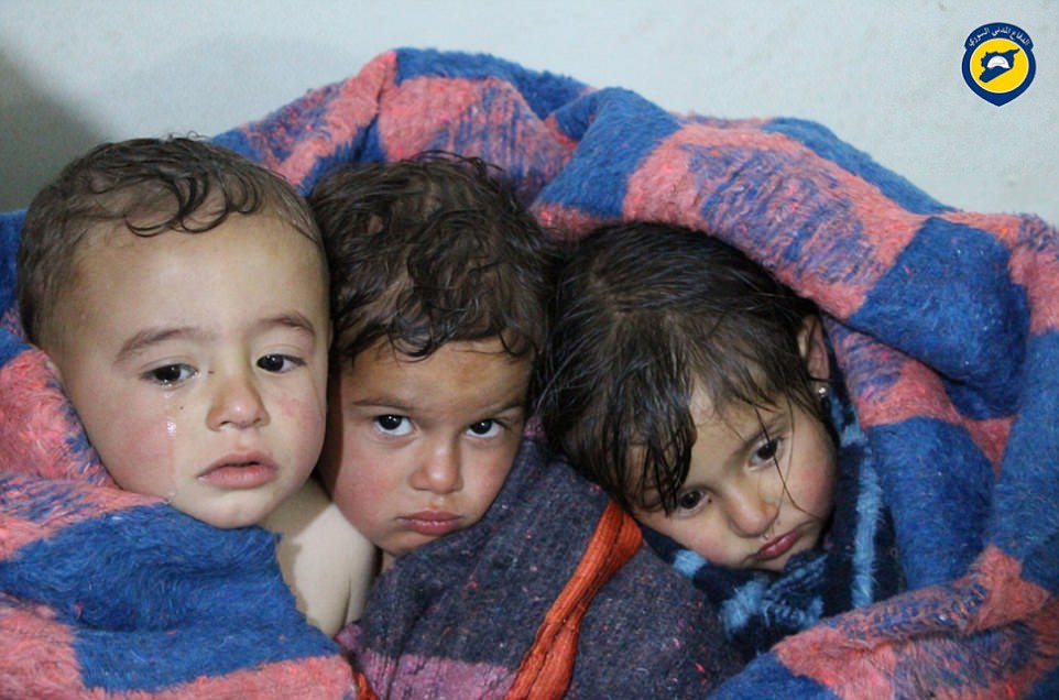 Russia's defense ministry said on Wednesday that a poisonous gas contamination in the Syrian town of Khan Sheikhoun was the result of gas leaking from a rebel chemical weapons depot after it was hit by Syrian government air strikes. Pictured above, children in Syria following the attacks