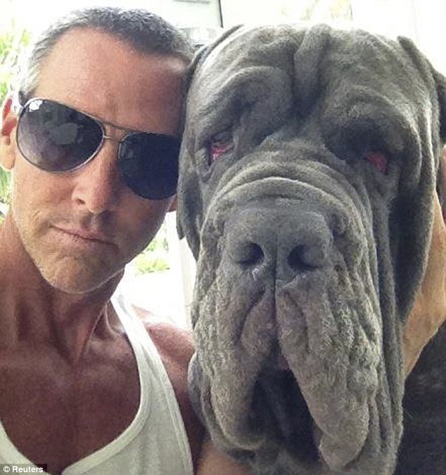 Loss: Michael Jarboe and his two-year-old Mastiff BamBam, who was found dead on arrival in San Francisco by baggage handlers following a flight layover in Houston in 90-degree heat