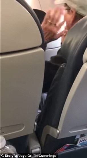 He then gets agitated and waves his hand at the cop and the flight attendant