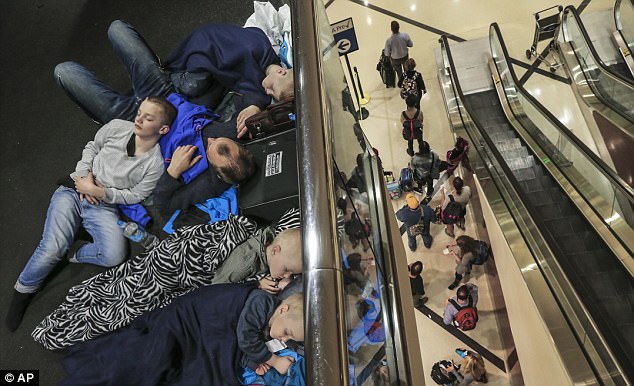 Several passengers were stranded at airports over the weekend after Delta cancelled and delayed thousands of flights (pictured people in Atlanta)