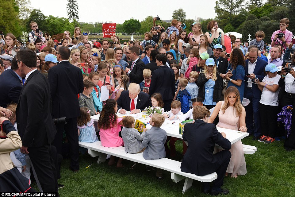 The president and first lady then joined young children on a picnic bench to complete drawings for the occasion 