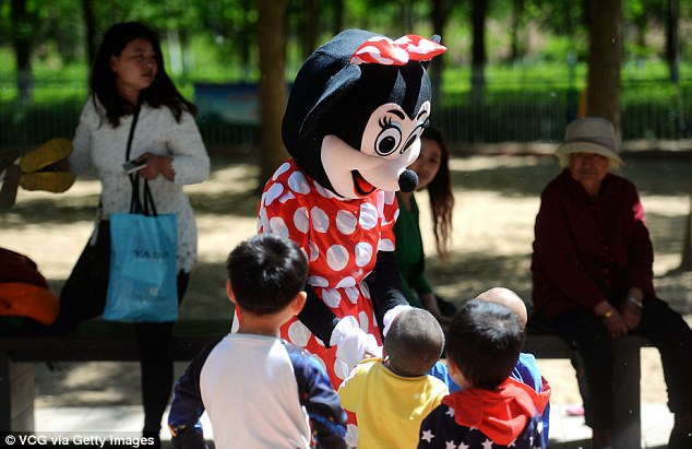 Tragic: Yin Pizhi dresses as Minnie Mouse and poses with tourists and charges for photos