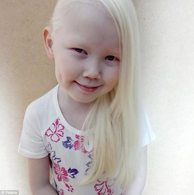 The little girl, with her long white hair, already appears to be confident in front of the camera