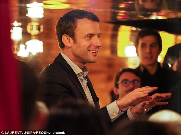 Macron (pictured celebrating the result at a restaurant last night) is clear favourite to become France's youngest president after topping Sunday's ballot with 23.75 per cent of votes, slightly ahead of National Front (FN) leader Le Pen on 21.53 per cent, according to final results