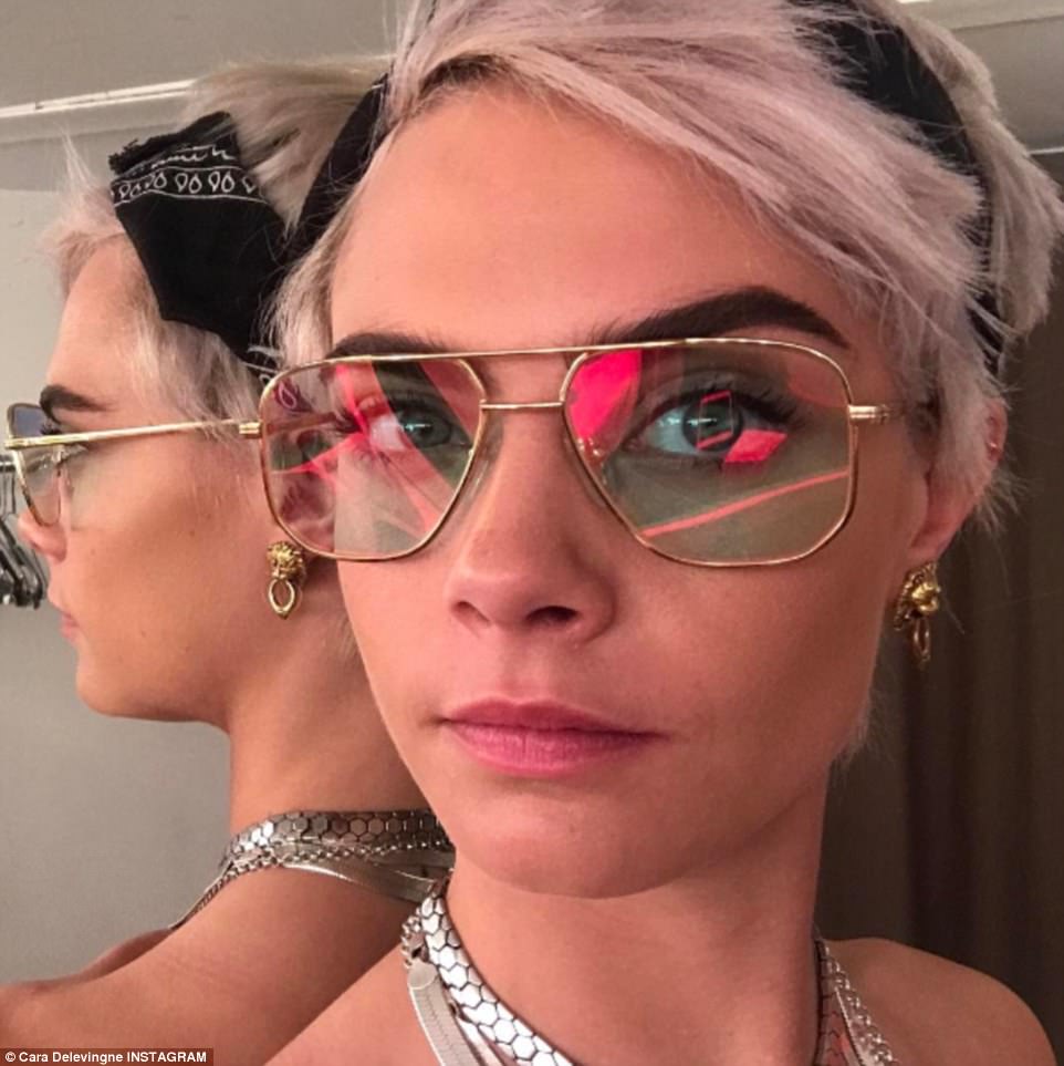 Model looks! Cara ditched her long trademark icy blonde locks for a pink-tinged crop in preparation for a more drastic hair look 