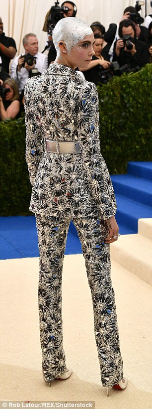Stunner: Cara has long been known for her edgy androgynous looks, with Monday being no exception as she dazzled in the glitzy two-piece which boasted a masculine shape but super girly glimmering adornments