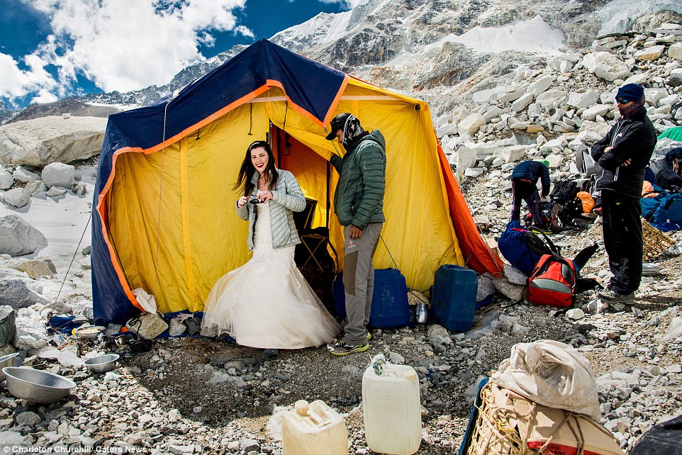 Touch of tradition: Ashley slipped into her breathtaking strapless wedding gown inside the team's tent, pictured