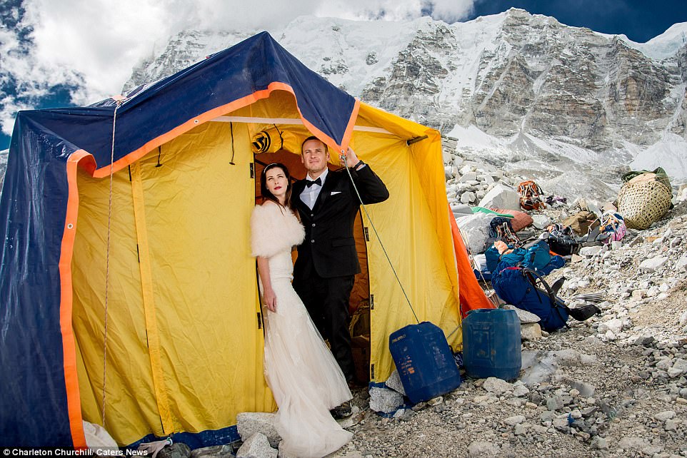 Contrast: Ashley and James stand in teir wedding finery, surrounded by the rugged majesty of the mountains