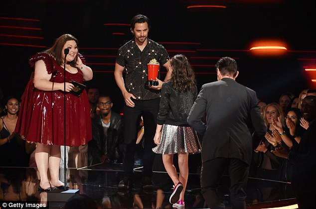 Happy days! Dafne and Hugh accept their awards on stage from the stars of the TV drama This Is Us Chrissy Metz and Milo Ventimiglia