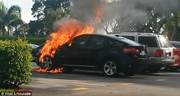 A parked 2012 BMW X6 is seen engulfed in flames in Delray Beach, Florida in July 2015