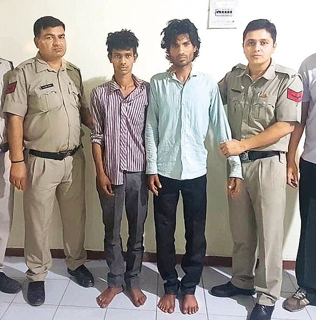 Sumit Kumar and his associate Vikas allegedly abducted the woman, and gang-raped and tortured her. The two men are shown between two police officers after their arrest