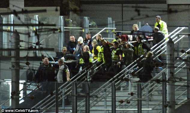 Witnesses told of nuts and bolts tearing into young music fans when the blast was detonated in the foyer area of Manchester Arena. Pictured: Concert-goers flee from the incident