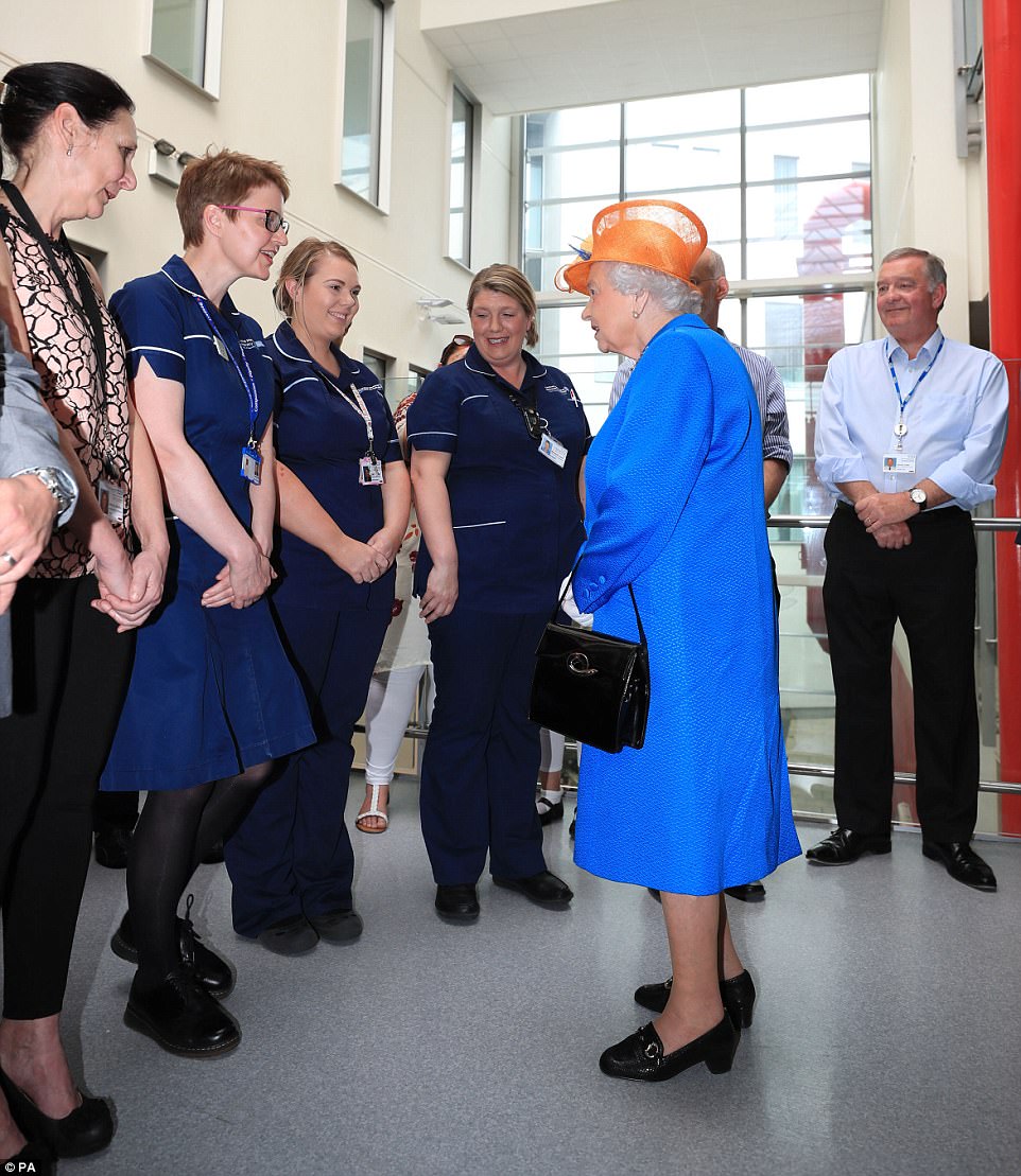 Gratitude: Hospital workers looked delighted to be meeting the Queen this morning