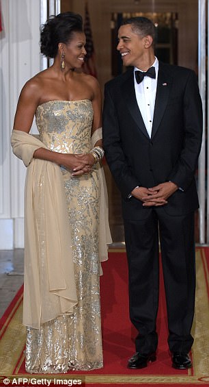 Obama noted how she was photographed and scrutinized year in and year out for the dresses and accessories she sported for state dinners. Above the couple is pictured at the state dinner in November 2009